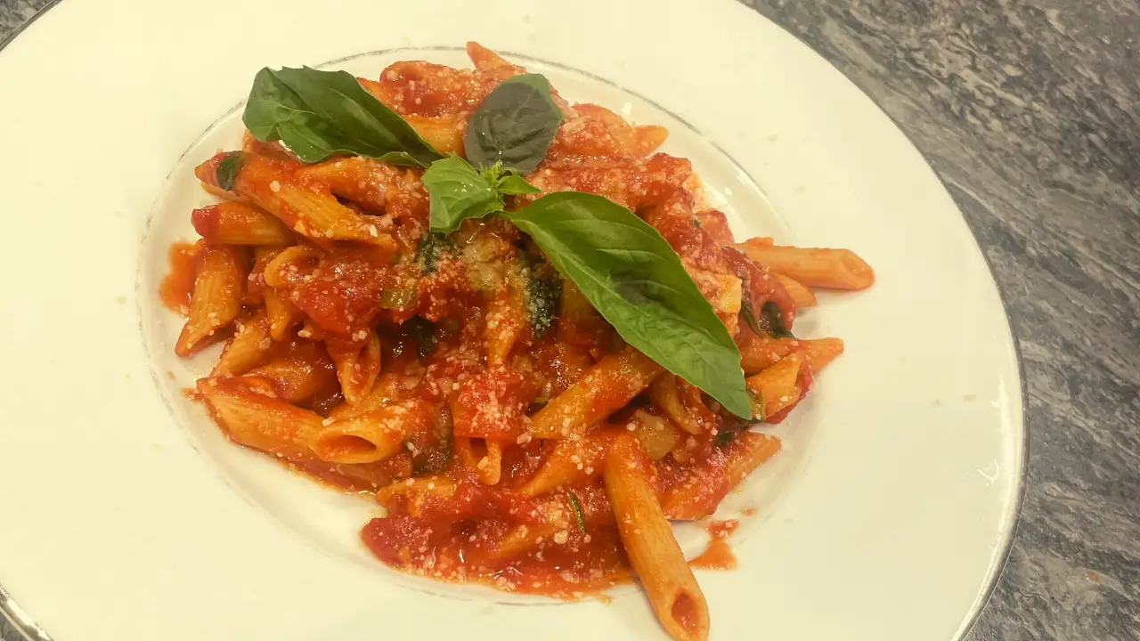 Penne pasta Arrabbiata with fresh Bazil and grated parmesan